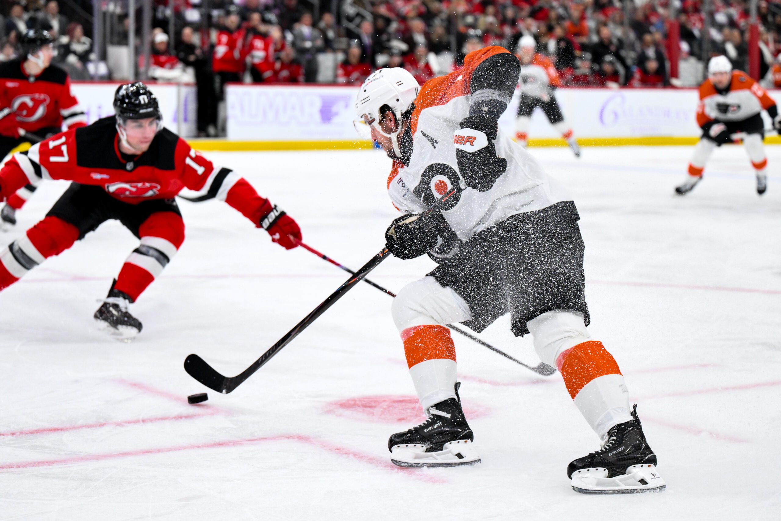 Nov 29, 2025; Newark, New Jersey, USA; Philadelphia Flyers right wing Travis Konecny (11) skates with the puck while defended by New Jersey Devils defenseman Simon Nemec (17) during the third period at Prudential Center. Mandatory Credit: John Jones-Imagn Images