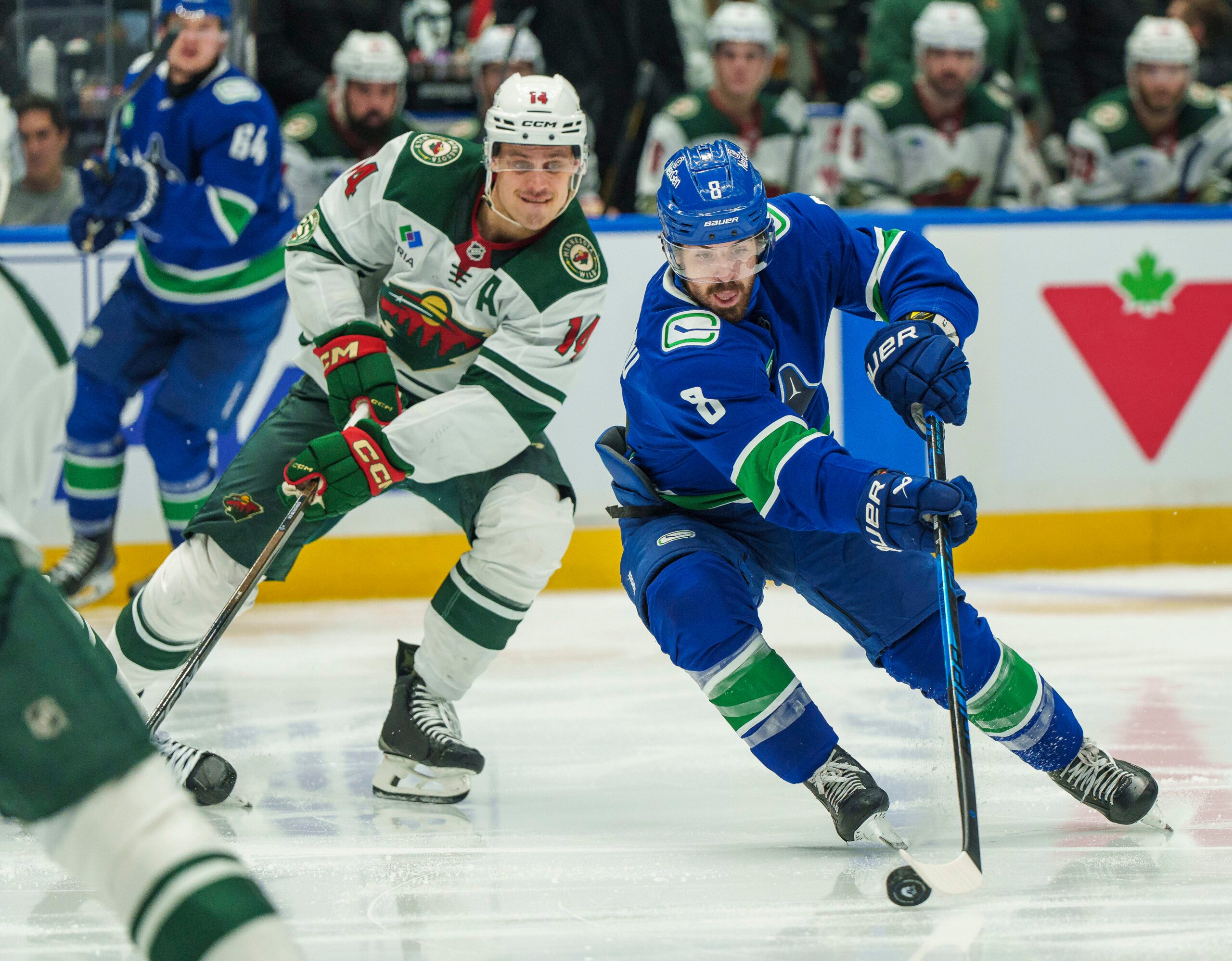 Dec 6, 2025; Vancouver, British Columbia, CAN; Vancouver Canucks left wing Conor Garland (8) gets past Minnesota Wild center Joel Eriksson Ek (14) in the third period at Rogers Arena. Mandatory Credit: Christopher Morris-Imagn Images