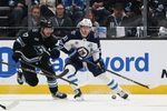 Dec 21, 2025; Salt Lake City, Utah, USA; Utah Mammoth center Barrett Hayton (27) and Winnipeg Jets left wing Kyle Connor (81) play for the puck during the third period at Delta Center. Mandatory Credit: Rob Gray-Imagn Images