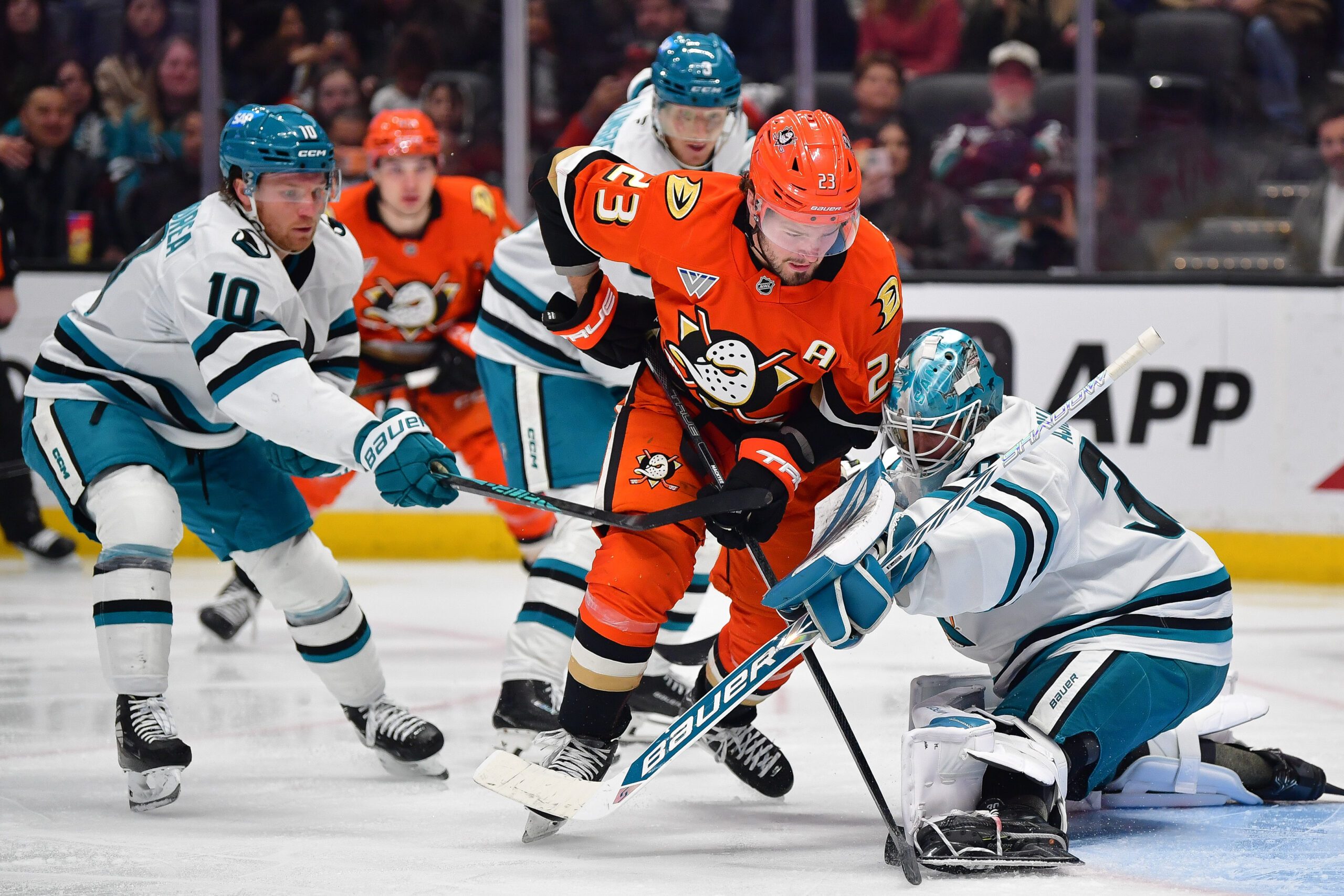 Dec 29, 2025; Anaheim, California, USA; San Jose Sharks goaltender Yaroslav Askarov (30) defends the goal against Anaheim Ducks center Mason McTavish (23) during the second period at Honda Center. Mandatory Credit: Gary A. Vasquez-Imagn Images
