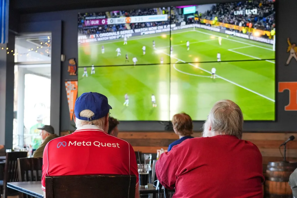 Mike Davis (left) and David Austin (right) watch a Manchester United FC game viewing at Fred's Around the Corner at 421 Union Ave in downtown Knoxville on Jan. 7, 2025.