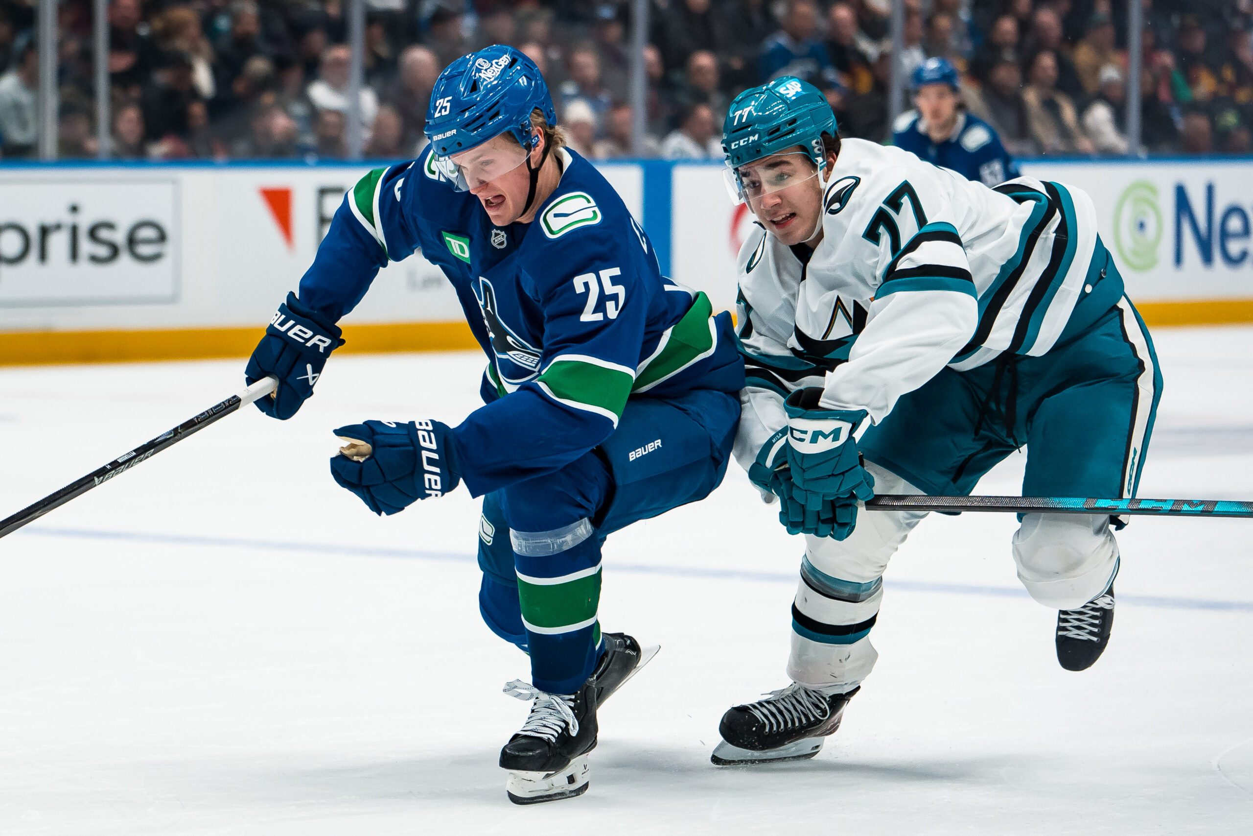 Jan 27, 2026; Vancouver, British Columbia, CAN; San Jose Sharks forward Michael Misa (77) battles with Vancouver Canucks defenseman Elias Pettersson (25) in the third period at Rogers Arena. Mandatory Credit: Bob Frid-Imagn Images