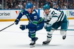 Jan 27, 2026; Vancouver, British Columbia, CAN; San Jose Sharks forward Michael Misa (77) battles with Vancouver Canucks defenseman Elias Pettersson (25) in the third period at Rogers Arena. Mandatory Credit: Bob Frid-Imagn Images