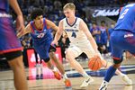 Feb 25, 2026; Omaha, Nebraska, USA;  Creighton Bluejays guard Josh Dix (4) drives against DePaul Blue Demons guard Kruz McClure (22) during the second half at CHI Health Center Omaha. Mandatory Credit: Steven Branscombe-Imagn Images