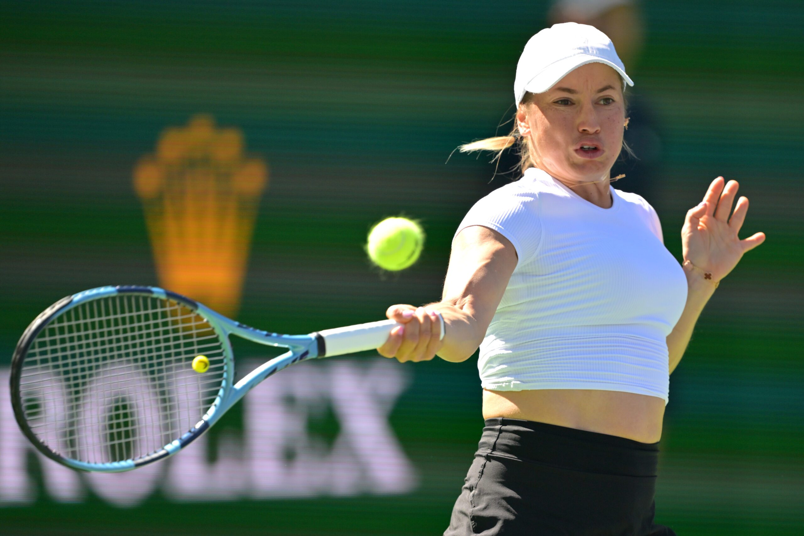 Mar 4, 2026; Indian Wells, CA, USA; Yulia Putintseva (KAZ) hits a shot against Paula Badosa (ESP) in her first round match during the BNP Paribas Open at the Indian Wells Tennis Garden. Mandatory Credit: Jayne Kamin-Oncea-Imagn Images