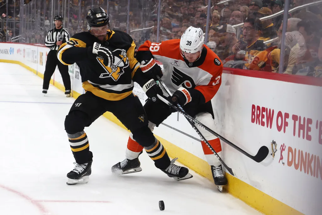 Mar 7, 2026; Pittsburgh, Pennsylvania, USA; Pittsburgh Penguins defenseman Erik Karlsson (65) and Philadelphia Flyers right wing Matvei Michkov (39) battle for the puck during the third period at PPG Paints Arena. Mandatory Credit: Charles LeClaire-Imagn Images