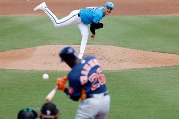 Mar 11, 2026; Jupiter, Florida, USA;  Miami Marlins pitcher Janson Junk (26) pitches to by Houston Astros left fielder Taylor Trammell during the fourth inning at Roger Dean Chevrolet Stadium. Mandatory Credit: Rhona Wise-Imagn Images