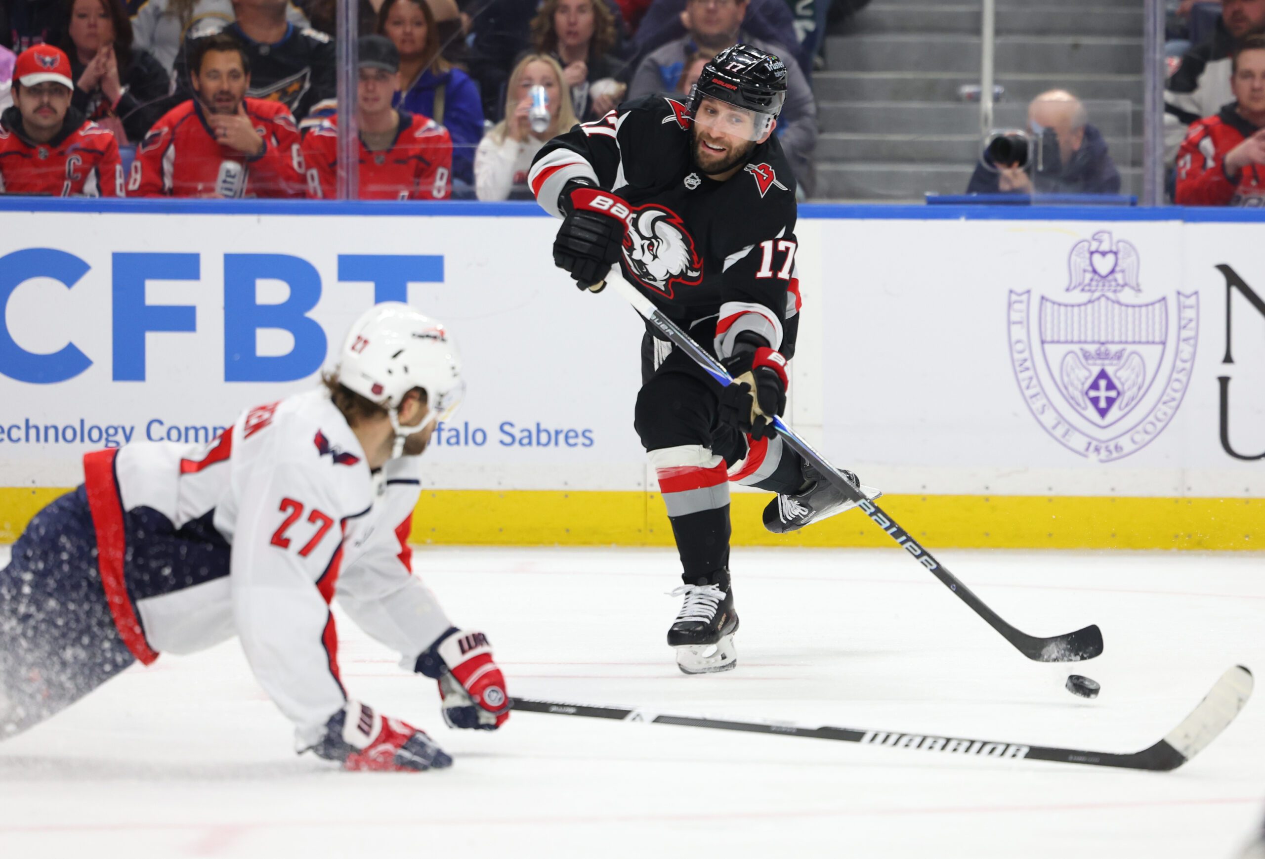 Mar 12, 2026; Buffalo, New York, USA; Washington Capitals defenseman Timothy Liljegren (27) tries to block a shot by Buffalo Sabres left wing Jason Zucker (17) during the second period at KeyBank Center. Mandatory Credit: Timothy T. Ludwig-Imagn Images