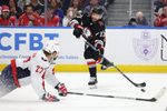 Mar 12, 2026; Buffalo, New York, USA;  Washington Capitals defenseman Timothy Liljegren (27) tries to block a shot by Buffalo Sabres left wing Jason Zucker (17) during the second period at KeyBank Center. Mandatory Credit: Timothy T. Ludwig-Imagn Images