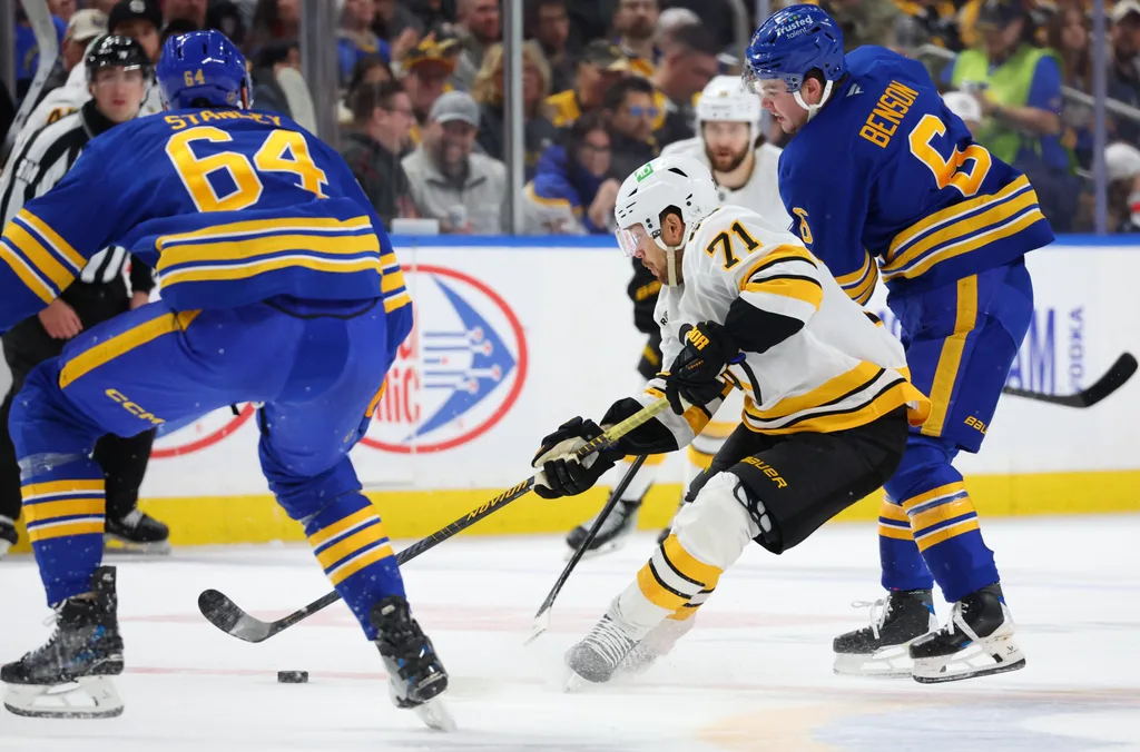 Mar 25, 2026; Buffalo, New York, USA; Boston Bruins left wing Viktor Arvidsson (71) controls the puck as Buffalo Sabres left wing Zach Benson (6) defends during the first period at KeyBank Center. Mandatory Credit: Timothy T. Ludwig-Imagn Images