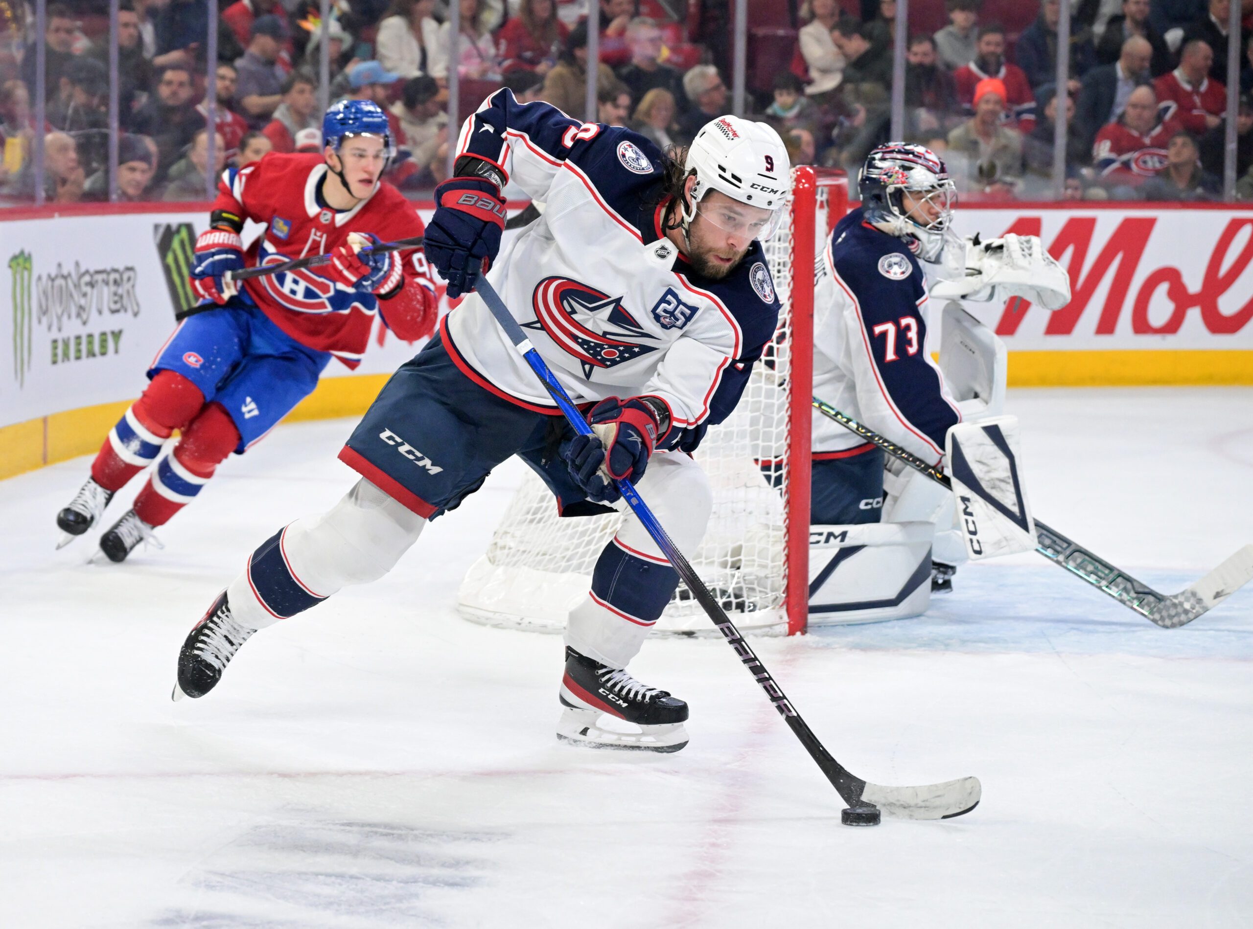 Mar 26, 2026; Montreal, Quebec, CAN; Columbus Blue Jackets defenseman Ivan Provorov (9) plays the puck and Montreal Canadiens forward Ivan Demidov (93) forechecks during the second period at the Bell Centre. Mandatory Credit: Eric Bolte-Imagn Images