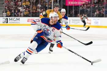 Mar 26, 2026; Las Vegas, Nevada, USA; Edmonton Oilers center Connor McDavid (97) controls the puck ahead of Vegas Golden Knights right wing Pavel Dorofeyev (16) during the first period at T-Mobile Arena. Mandatory Credit: Stephen R. Sylvanie-Imagn Images