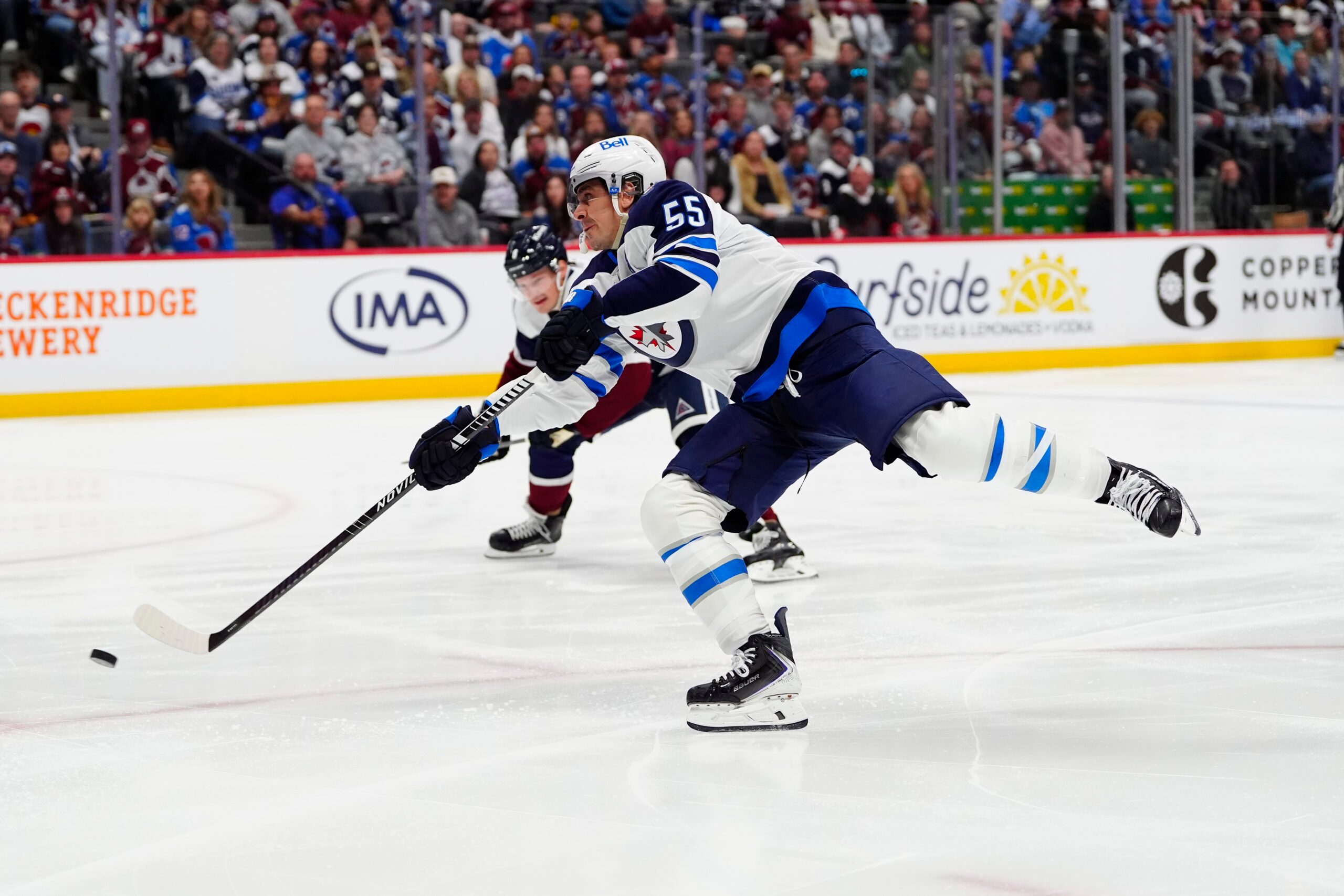 Mar 28, 2026; Denver, Colorado, USA; Winnipeg Jets center Mark Scheifele (55) shoots the puck in the first period against the Colorado Avalanche at Ball Arena. Mandatory Credit: Ron Chenoy-Imagn Images
