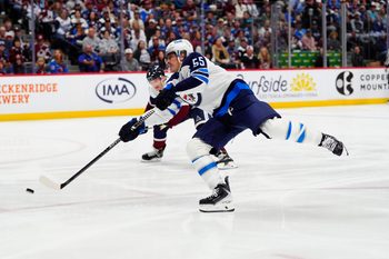 Mar 28, 2026; Denver, Colorado, USA; Winnipeg Jets center Mark Scheifele (55) shoots the puck in the first period against the Colorado Avalanche at Ball Arena. Mandatory Credit: Ron Chenoy-Imagn Images