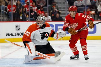 Mar 28, 2026; Detroit, Michigan, USA;  Philadelphia Flyers goaltender Dan Vladar (80) makes a save in front of Detroit Red Wings right wing Patrick Kane (88) in the second period at Little Caesars Arena. Mandatory Credit: Rick Osentoski-Imagn Images