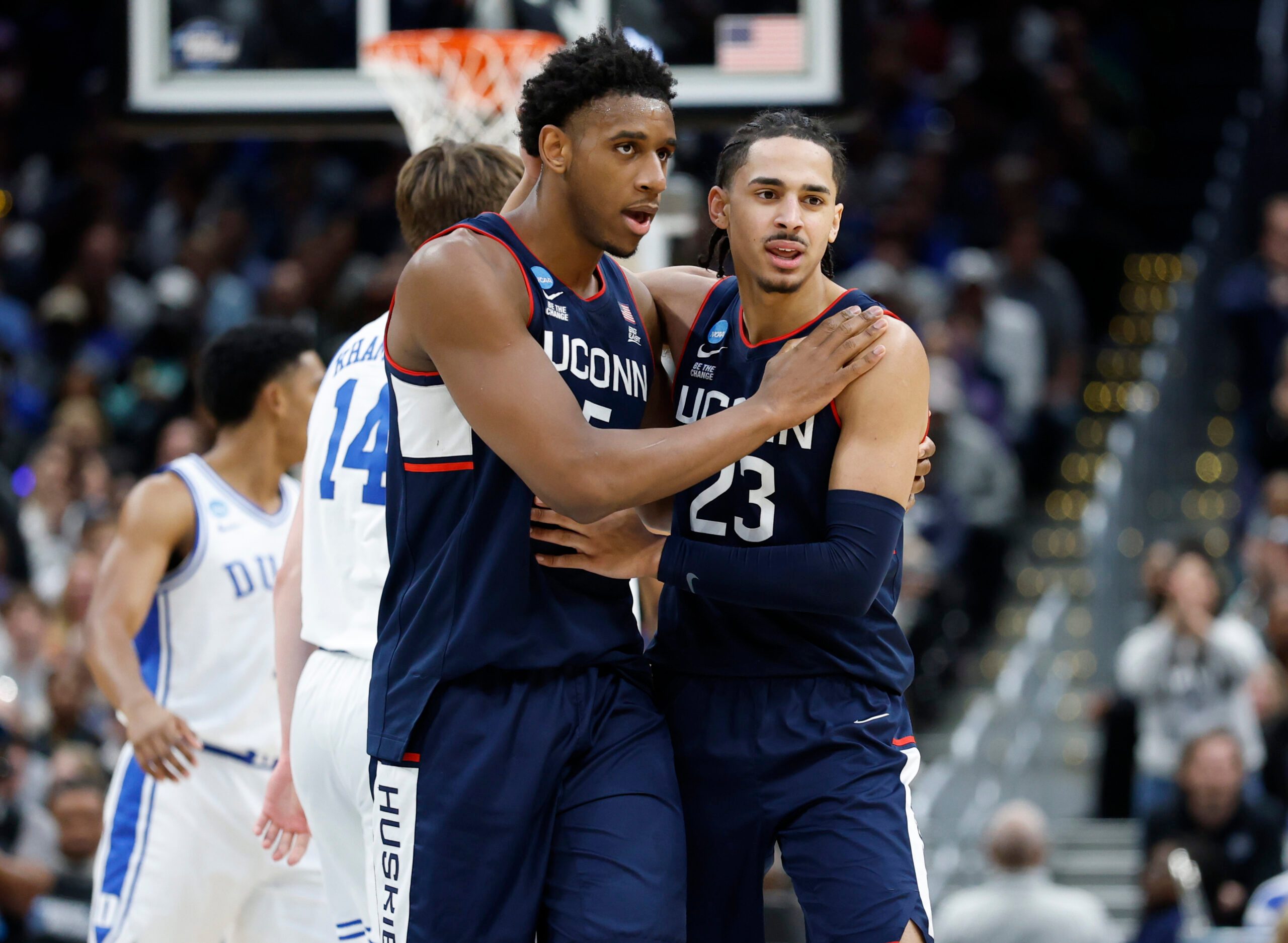 Mar 29, 2026; Washington, DC, USA; UConn Huskies forward Tarris Reed Jr. (5) and UConn Huskies forward Jayden Ross (23) celebrate after a play against the Duke Blue Devils in the second half during an Elite Eight game of the East Regional of the men's 2026 NCAA Tournament at Capital One Arena. Mandatory Credit: Amber Searls-Imagn Images