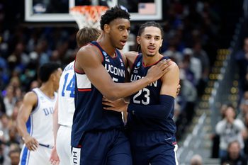 Mar 29, 2026; Washington, DC, USA; UConn Huskies forward Tarris Reed Jr. (5) and UConn Huskies forward Jayden Ross (23) celebrate after a play against the Duke Blue Devils in the second half during an Elite Eight game of the East Regional of the men's 2026 NCAA Tournament at Capital One Arena. Mandatory Credit: Amber Searls-Imagn Images
