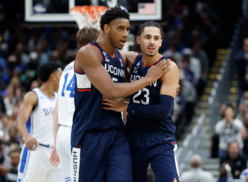 Mar 29, 2026; Washington, DC, USA; UConn Huskies forward Tarris Reed Jr. (5) and UConn Huskies forward Jayden Ross (23) celebrate after a play against the Duke Blue Devils in the second half during an Elite Eight game of the East Regional of the men's 2026 NCAA Tournament at Capital One Arena. Mandatory Credit: Amber Searls-Imagn Images