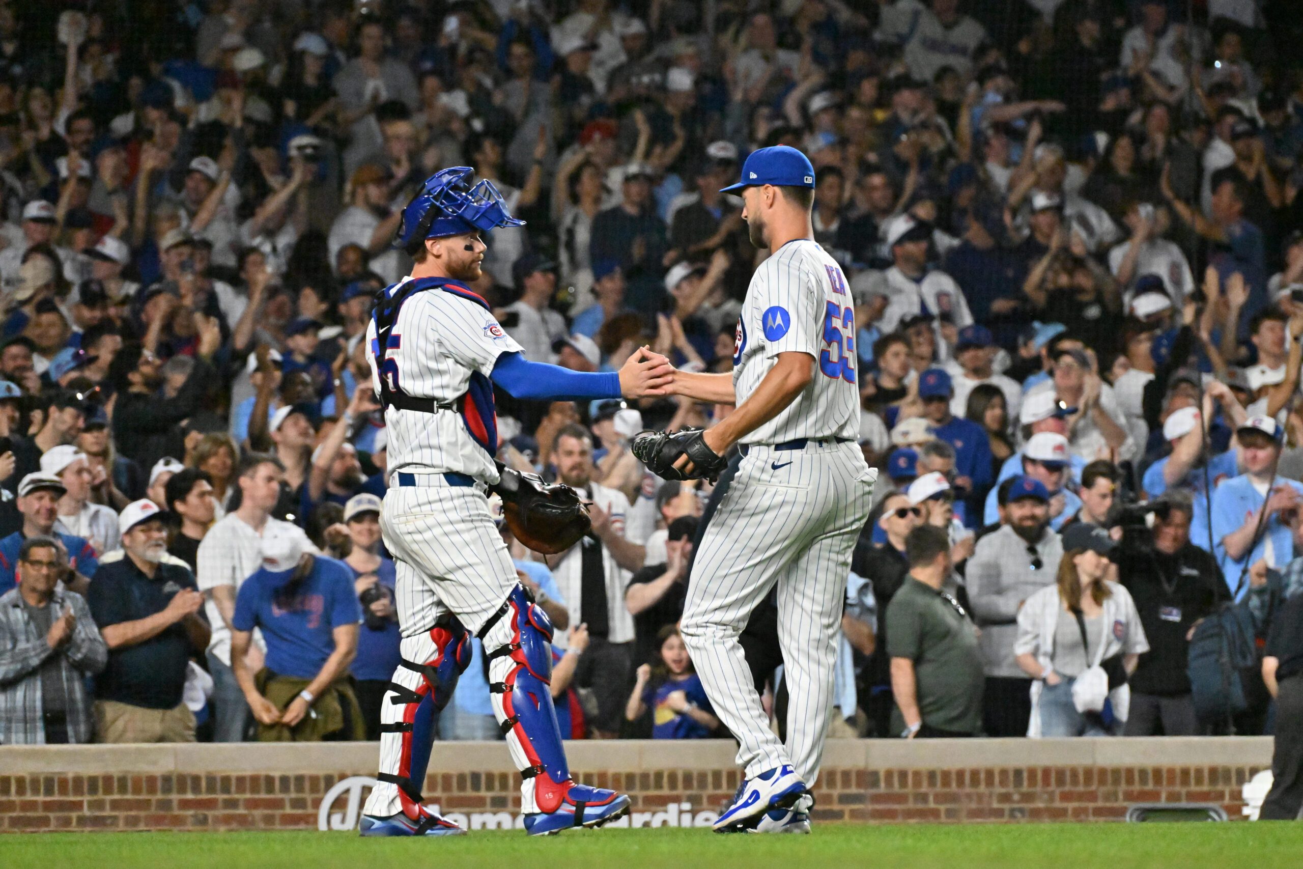 Mar 30, 2026; Chicago, Illinois, USA; Chicago Cubs catcher Carson Kelly (15) and pitcher Colin Rea (53) celebrate their victory over the Los Angeles Angels at Wrigley Field. Mandatory Credit: Patrick Gorski-Imagn Images