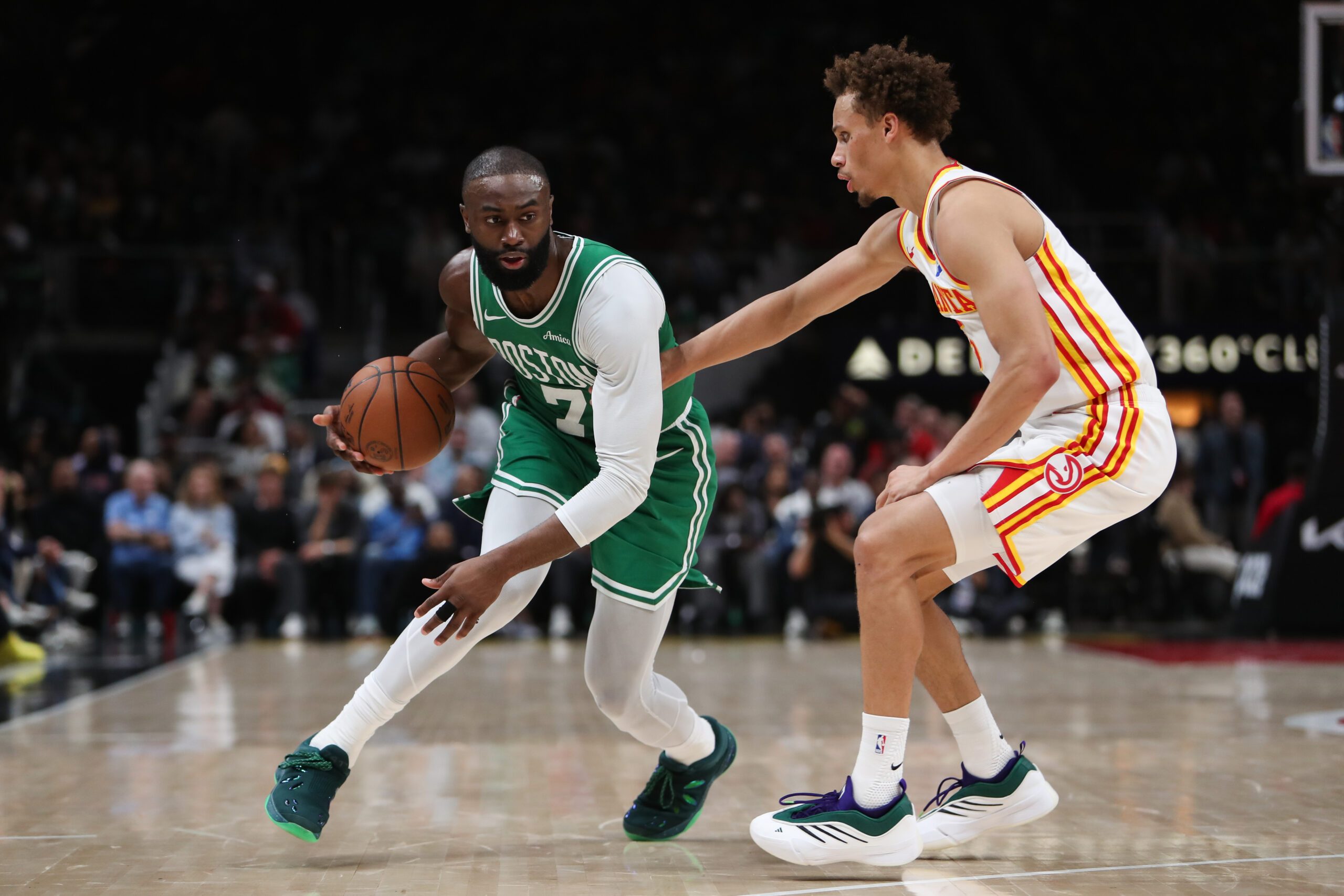 Mar 30, 2026; Atlanta, Georgia, USA; Boston Celtics guard Jaylen Brown (7) dribbles against Atlanta Hawks guard Dyson Daniels (5) in the first half at State Farm Arena. Mandatory Credit: Mady Mertens-Imagn Images