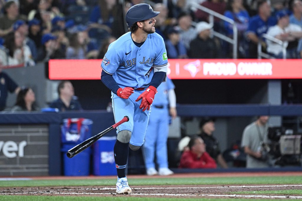 Mar 31, 2026; Toronto, Ontario, CAN; Toronto Blue Jays second baseman Ernie Clement (22) hits an RBI double against the Colorado Rockies in the seventh inning at Rogers Centre. Mandatory Credit: Dan Hamilton-Imagn Images