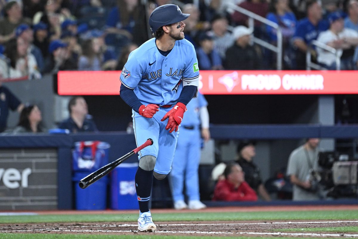 Mar 31, 2026; Toronto, Ontario, CAN; Toronto Blue Jays second baseman Ernie Clement (22) hits an RBI double against the Colorado Rockies in the seventh inning at Rogers Centre. Mandatory Credit: Dan Hamilton-Imagn Images