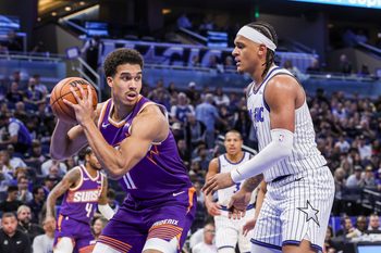 Mar 31, 2026; Orlando, Florida, USA; Phoenix Suns forward Oso Ighodaro (11) looks to pass in front of Orlando Magic forward Paolo Banchero (5) during the second half at Kia Center. Mandatory Credit: Mike Watters-Imagn Images
