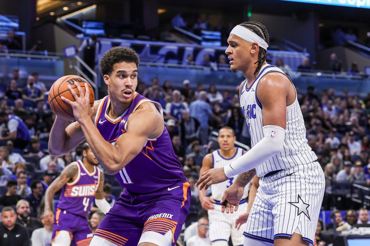 Mar 31, 2026; Orlando, Florida, USA; Phoenix Suns forward Oso Ighodaro (11) looks to pass in front of Orlando Magic forward Paolo Banchero (5) during the second half at Kia Center. Mandatory Credit: Mike Watters-Imagn Images