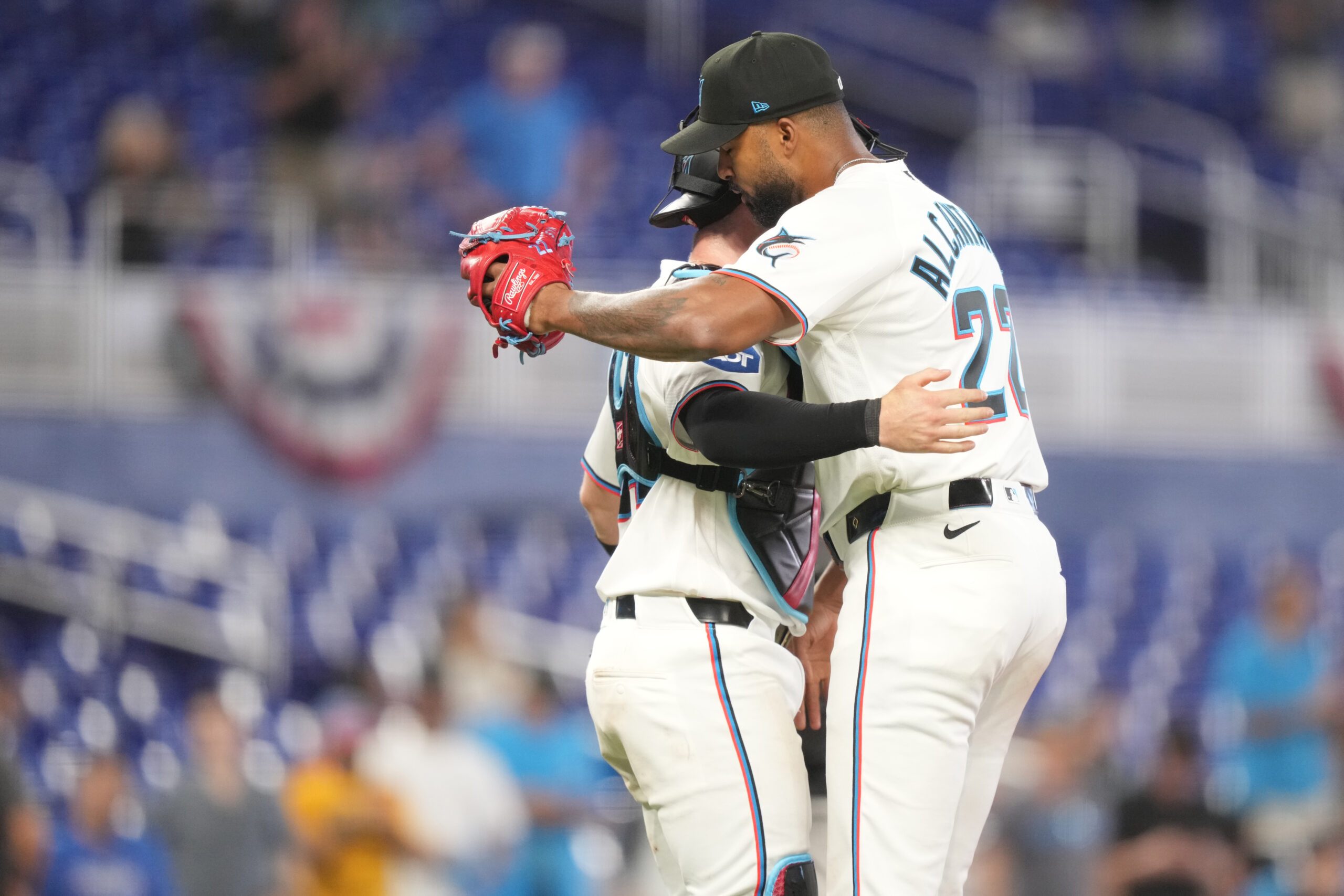 Apr 1, 2026; Miami, Florida, USA;  Miami Marlins starting pitcher Sandy Alcantara (22) gets a hug following his complete game shutout win over the Chicago White Sox by catcher Liam Hicks (34) at loanDepot Park. Mandatory Credit: Jim Rassol-Imagn Images