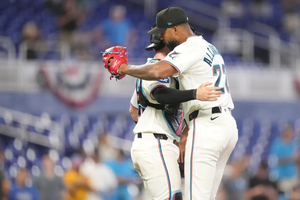 Apr 1, 2026; Miami, Florida, USA; Miami Marlins starting pitcher Sandy Alcantara (22) gets a hug following his complete game shutout win over the Chicago White Sox by catcher Liam Hicks (34) at loanDepot Park. Mandatory Credit: Jim Rassol-Imagn Images