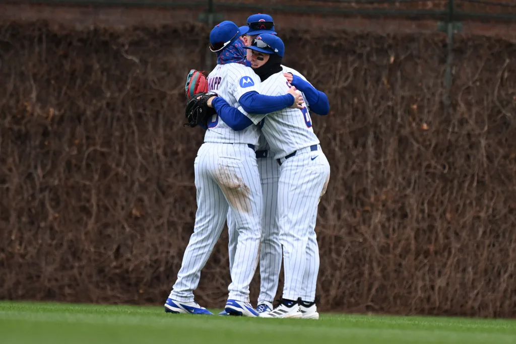 Apr 1, 2026; Chicago, Illinois, USA; Chicago Cubs right fielder Matt Shaw (6) left fielder Ian Happ (8) and center fielder Pete Crow-Armstrong (4) hug after the game against the Los Angeles Angels at Wrigley Field. Mandatory Credit: Matt Marton-Imagn Images