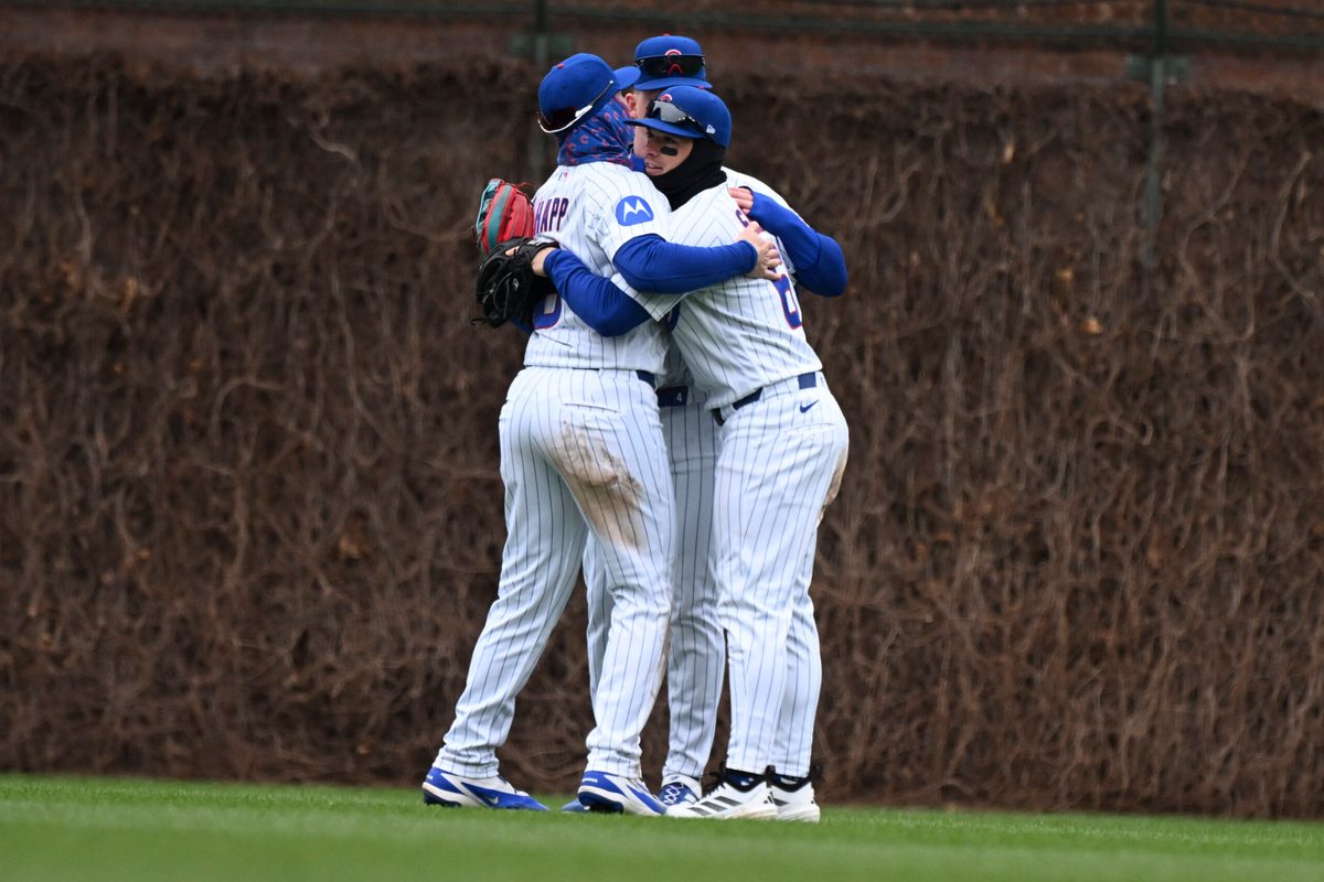 Apr 1, 2026; Chicago, Illinois, USA; Chicago Cubs right fielder Matt Shaw (6) left fielder Ian Happ (8) and center fielder Pete Crow-Armstrong (4) hug after the game against the Los Angeles Angels at Wrigley Field. Mandatory Credit: Matt Marton-Imagn Images