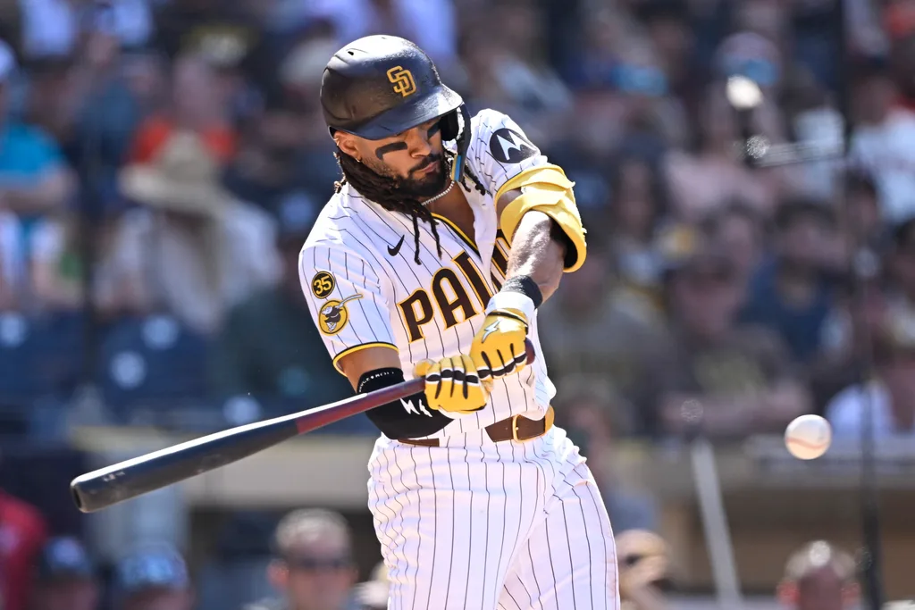 Apr 1, 2026; San Diego, California, USA; San Diego Padres right fielder Fernando Tatis Jr. (23) hits an RBI single during the eighth inning against the San Francisco Giants at Petco Park. Mandatory Credit: Denis Poroy-Imagn Images