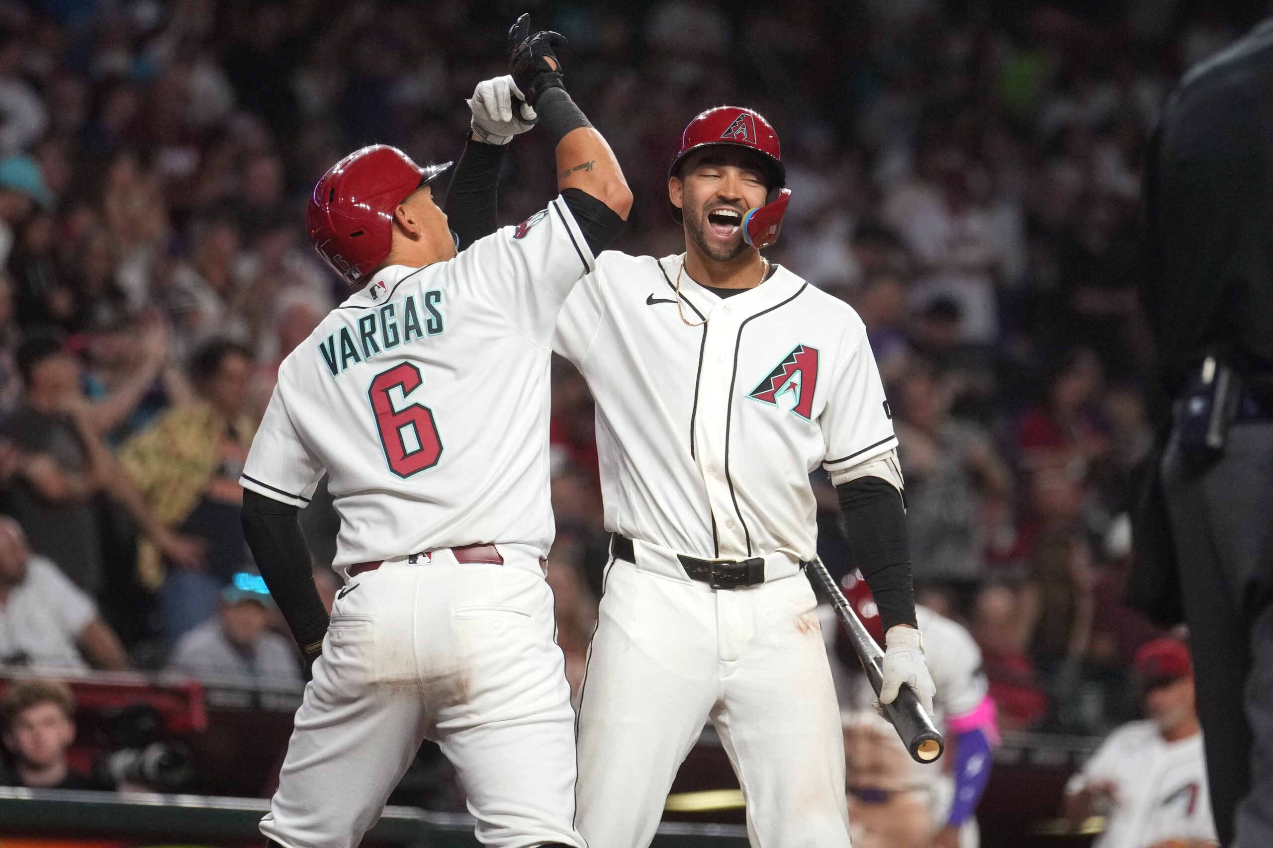 Arizona Diamondbacks' Ildemaro Vargas (6) celebrates his solo home run with teammate Jordan Lawlar (10) during their game against the Detroit Tigers at Chase Field on March 30, 2026.