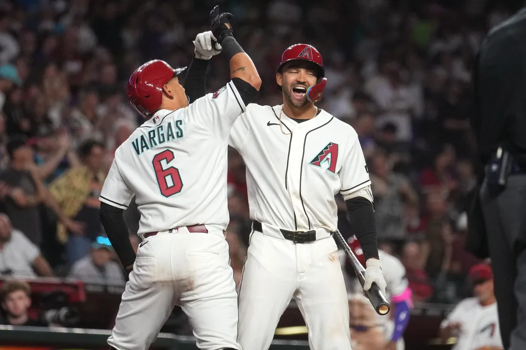 Arizona Diamondbacks' Ildemaro Vargas (6) celebrates his solo home run with teammate Jordan Lawlar (10) during their game against the Detroit Tigers at Chase Field on March 30, 2026.