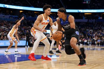 Apr 1, 2026; Orlando, Florida, USA; Orlando Magic forward Paolo Banchero (5) is guarded by Atlanta Hawks forward Jalen Johnson (1) in the third quarter at Kia Center. Mandatory Credit: Nathan Ray Seebeck-Imagn Images