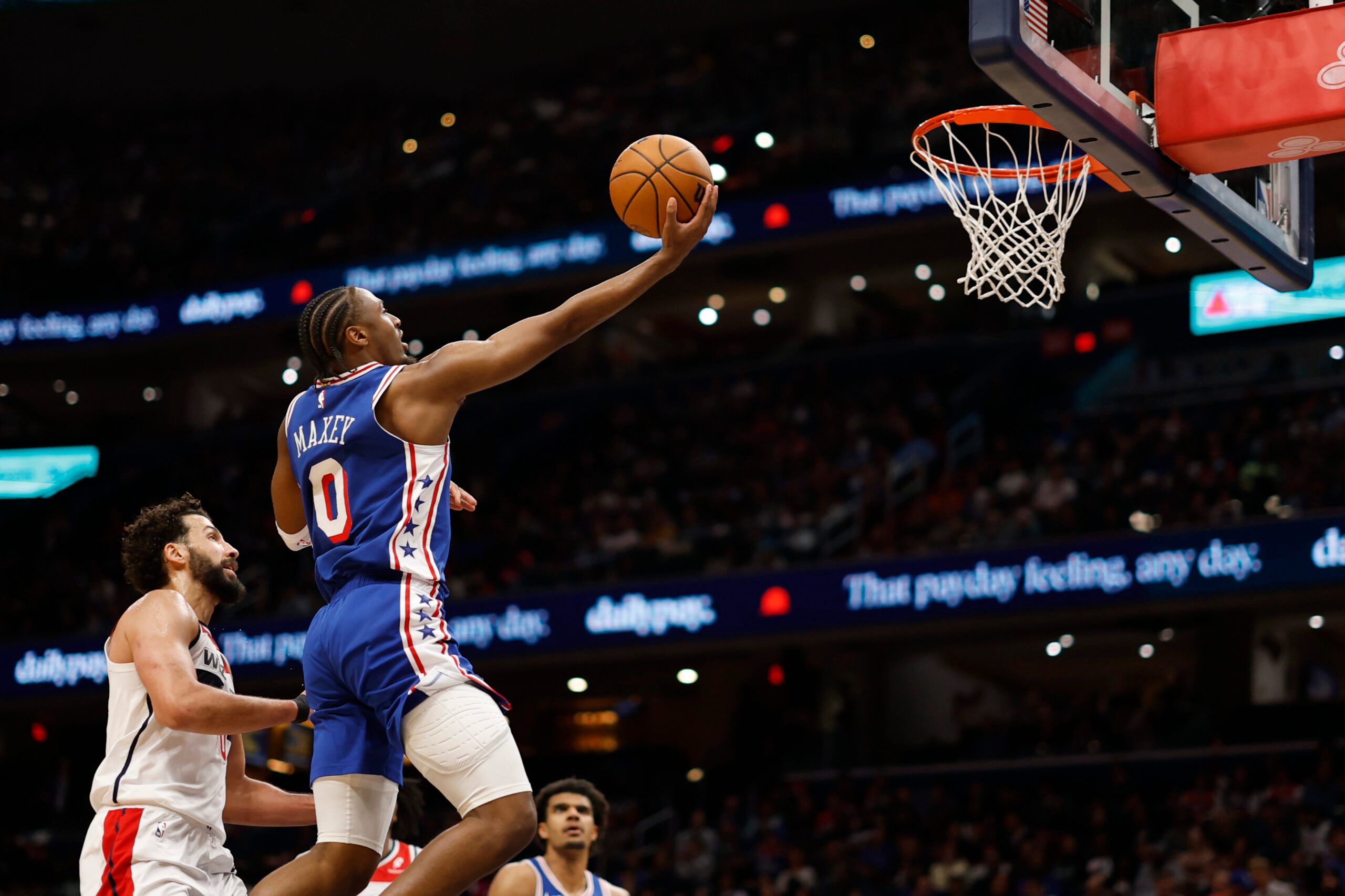 Apr 1, 2026; Washington, District of Columbia, USA; Philadelphia 76ers guard Tyrese Maxey (0) shoots the ball as Washington Wizards forward Anthony Gill (16) defends in the first half at Capital One Arena. Mandatory Credit: Geoff Burke-Imagn Images