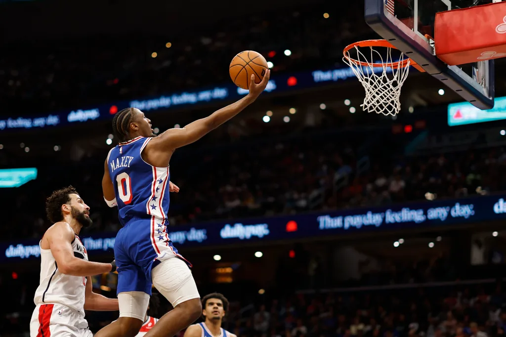 Apr 1, 2026; Washington, District of Columbia, USA; Philadelphia 76ers guard Tyrese Maxey (0) shoots the ball as Washington Wizards forward Anthony Gill (16) defends in the first half at Capital One Arena. Mandatory Credit: Geoff Burke-Imagn Images