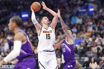 Apr 1, 2026; Salt Lake City, Utah, USA;  Denver Nuggets center Nikola Jokić (15) shoots the ball over Utah Jazz guard John Konchar (55) during the second half at Delta Center. Mandatory Credit: Chris Nicoll-Imagn Images