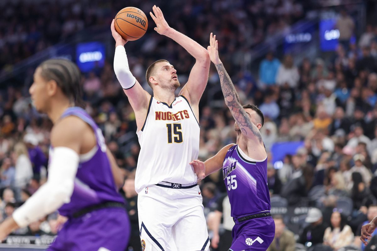 Apr 1, 2026; Salt Lake City, Utah, USA; Denver Nuggets center Nikola Jokić (15) shoots the ball over Utah Jazz guard John Konchar (55) during the second half at Delta Center. Mandatory Credit: Chris Nicoll-Imagn Images