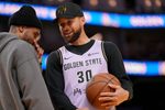 Apr 1, 2026; San Francisco, California, USA; Golden State Warriors guard Stephen Curry (30) talks with guard Gary Payton II (0) during a timeout against the San Antonio Spurs in the fourth quarter at the Chase Center. Mandatory Credit: Cary Edmondson-Imagn Images
