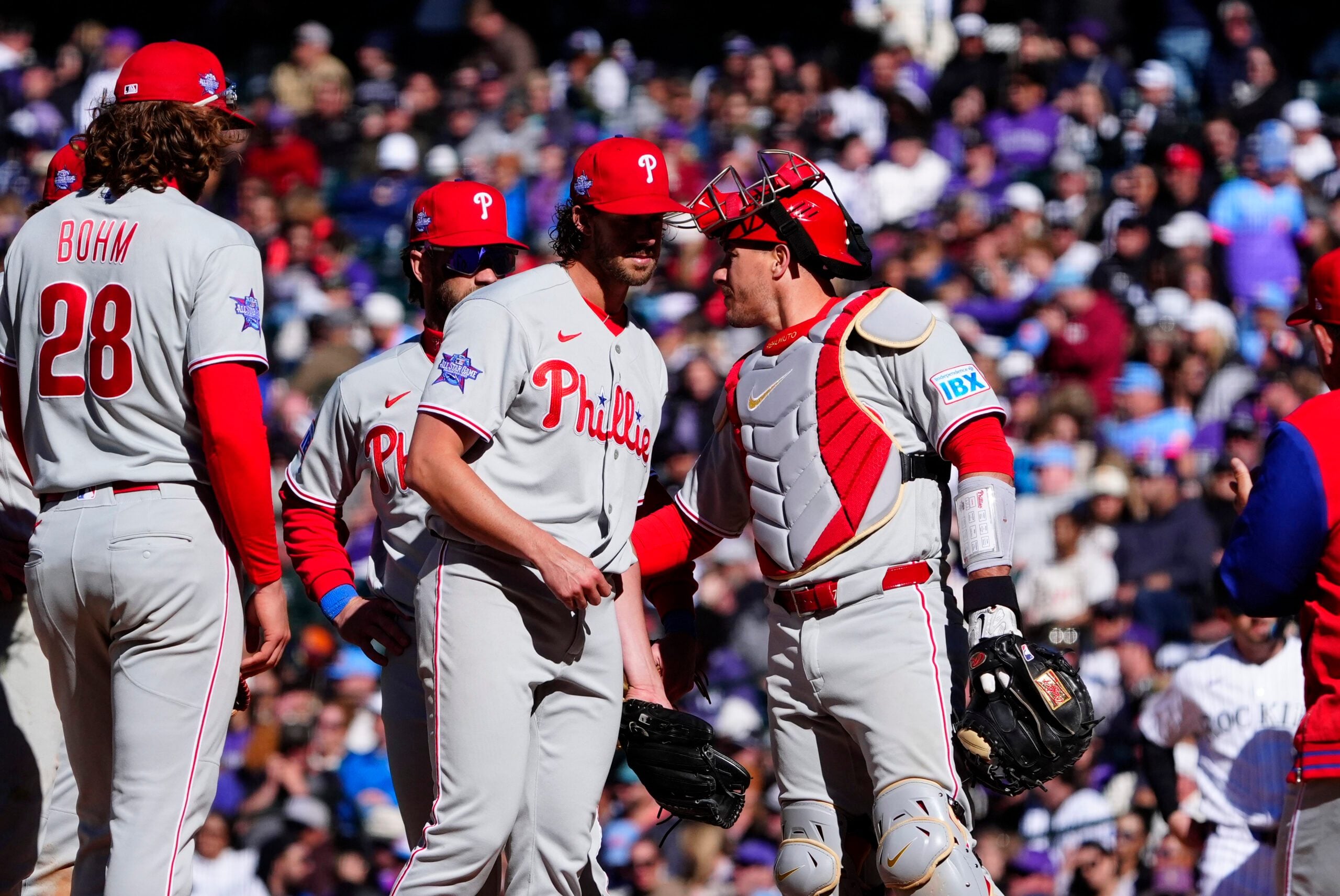 Apr 3, 2026; Denver, Colorado, USA; Philadelphia Phillies catcher J.T. Realmuto (10) congratulates starting pitcher Aaron Nola (27) during the seventh inning against the Colorado Rockies at Coors Field. Mandatory Credit: Ron Chenoy-Imagn Images