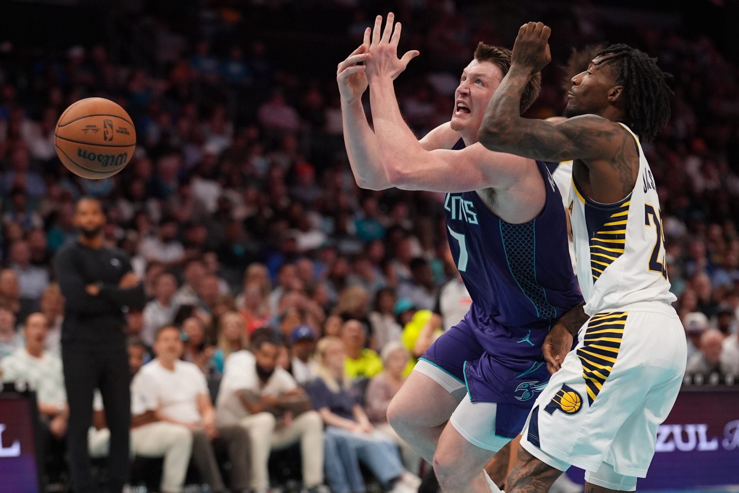 Apr 3, 2026; Charlotte, North Carolina, USA; Charlotte Hornets guard/forward Kon Knueppel (7) loses the ball and is fouled by Indiana Pacers guard Quenton Jackson (29) during the second half at Spectrum Center. Mandatory Credit: Jim Dedmon-Imagn Images