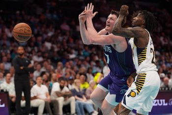 Apr 3, 2026; Charlotte, North Carolina, USA; Charlotte Hornets guard/forward Kon Knueppel (7) loses the ball and is fouled by Indiana Pacers guard Quenton Jackson (29) during the second half at Spectrum Center. Mandatory Credit: Jim Dedmon-Imagn Images
