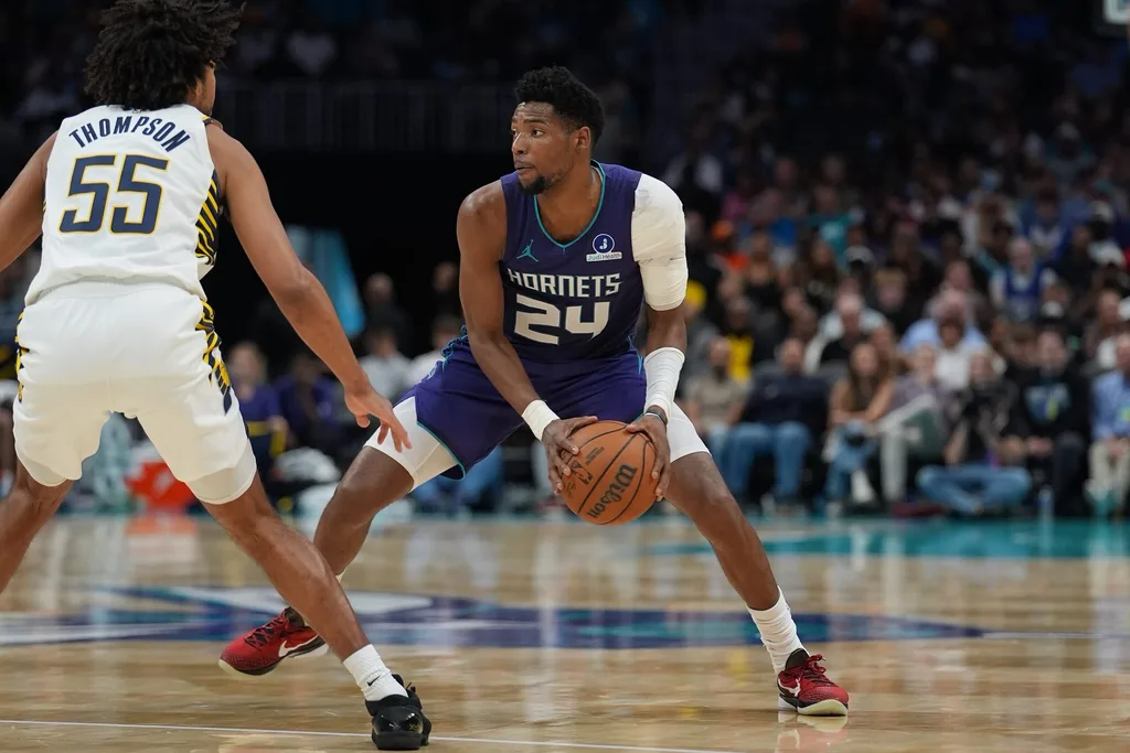 Apr 3, 2026; Charlotte, North Carolina, USA; Charlotte Hornets forward Brandon Miller (24) handles the ball defended by Indiana Pacers guard Ethan Thompson (55) during the second half at Spectrum Center. Mandatory Credit: Jim Dedmon-Imagn Images