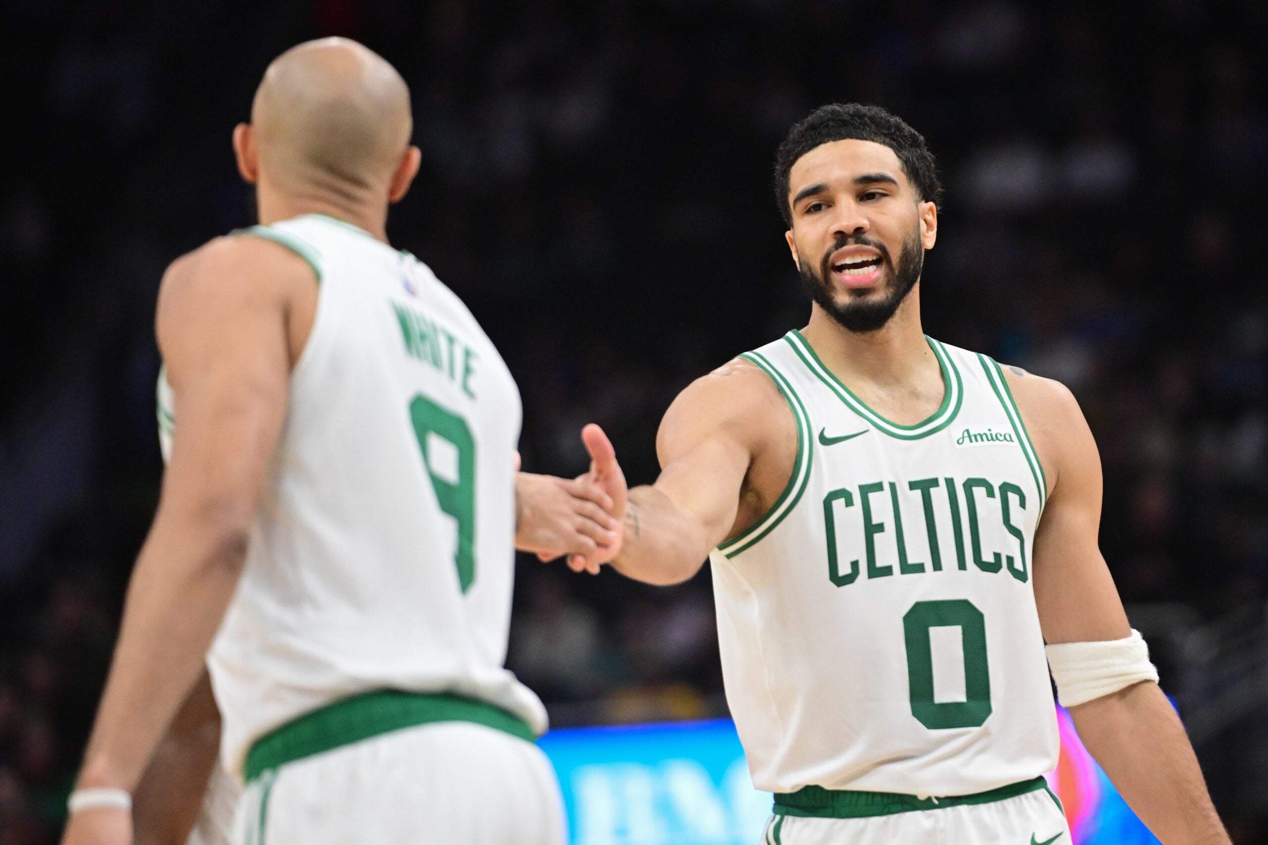 Apr 3, 2026; Milwaukee, Wisconsin, USA; Boston Celtics forward Jayson Tatum (0) reacts with guard Derrick White (9) after scoring a basket against the Milwaukee Bucks at Fiserv Forum. Mandatory Credit: Benny Sieu-Imagn Images