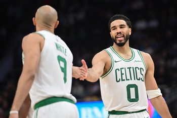 Apr 3, 2026; Milwaukee, Wisconsin, USA; Boston Celtics forward Jayson Tatum (0) reacts with guard Derrick White (9) after scoring a basket against the Milwaukee Bucks at Fiserv Forum. Mandatory Credit: Benny Sieu-Imagn Images