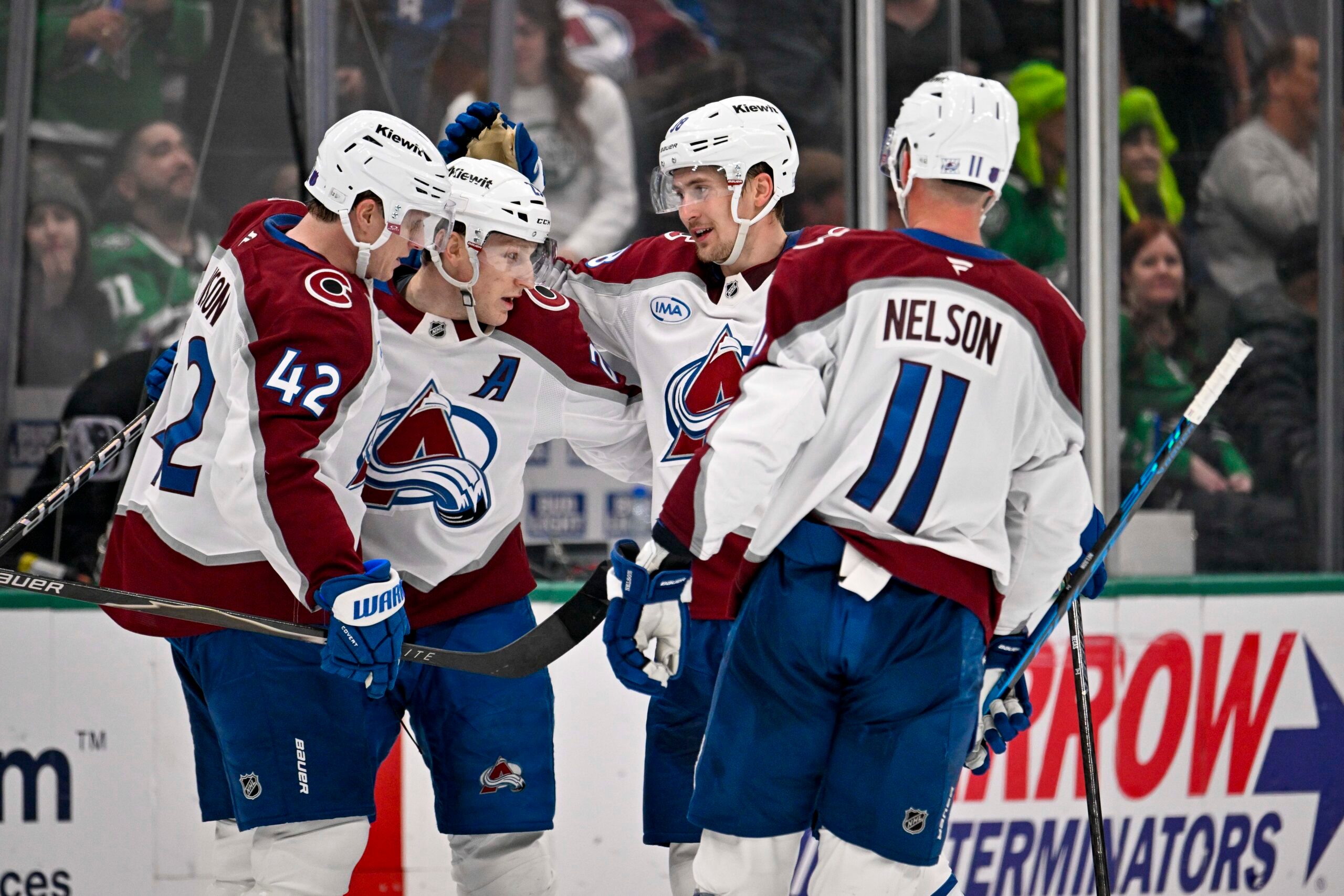 Apr 4, 2026; Dallas, Texas, USA; Colorado Avalanche defenseman Josh Manson (42) and center Nathan MacKinnon (29) and center Martin Necas (88) and center Brock Nelson (11) celebrates an empty goal scored by MacKinnon against the Dallas Stars during the third period at the American Airlines Center. Mandatory Credit: Jerome Miron-Imagn Images
