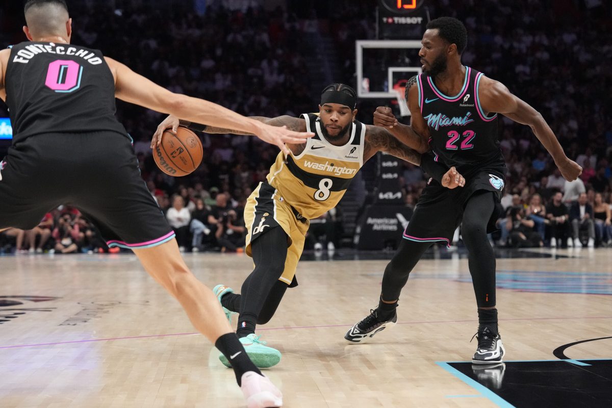 Apr 4, 2026; Miami, Florida, USA;  Washington Wizards guard Jaden Hardy (8) splits the defense of Miami Heat forward Andrew Wiggins (22) and forward Simone Fontecchio (0) during the second half at Kaseya Center. Mandatory Credit: Jim Rassol-Imagn Images
