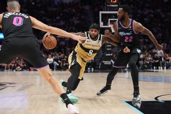 Apr 4, 2026; Miami, Florida, USA;  Washington Wizards guard Jaden Hardy (8) splits the defense of Miami Heat forward Andrew Wiggins (22) and forward Simone Fontecchio (0) during the second half at Kaseya Center. Mandatory Credit: Jim Rassol-Imagn Images